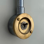 Brassvane raw brass conduit light switch overall view